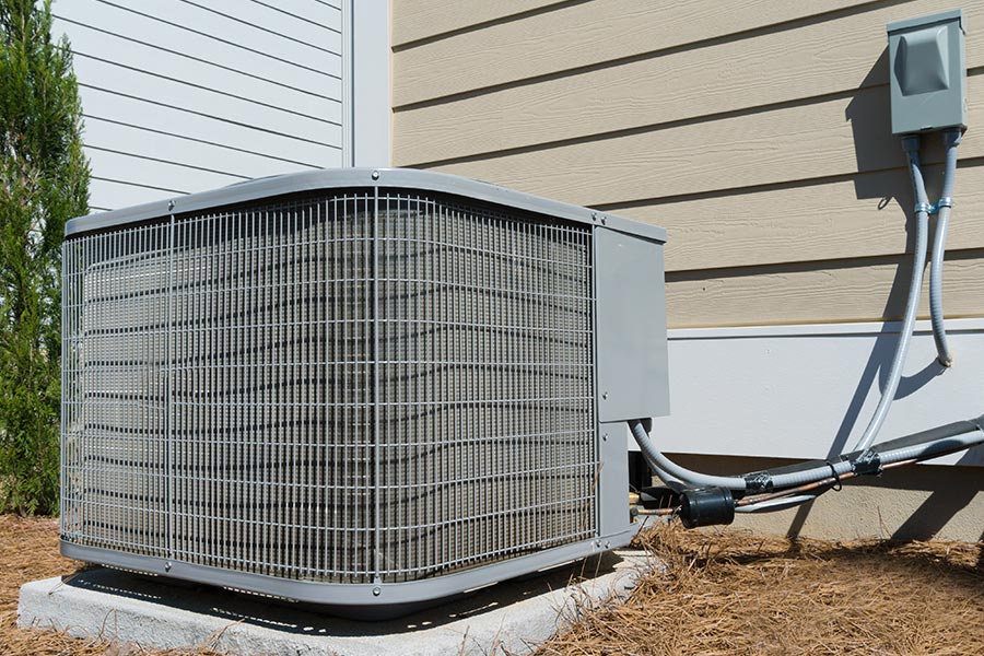 Outdoor air conditioner unit by a house